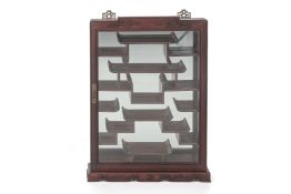 A CHINESE HARDWOOD GLAZED WALL MOUNTED DISPLAY CABINET