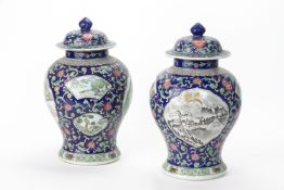 A PAIR OF POLYCHROME ENAMELLED PORCELAIN JARS AND COVERS