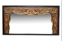 A VERY LARGE CARVED AND GILT WALL MIRROR