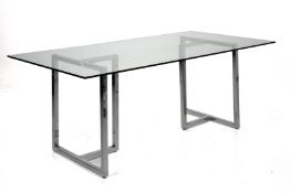 A CONTEMPORARY GLASS AND CHROME DINING TABLE