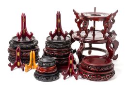 A LARGE ASSORTMENT OF ORIENTAL WOOD STANDS