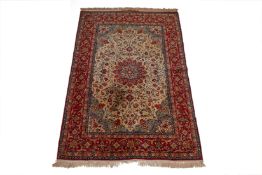 A MIDDLE EASTERN RED GROUND SILK RUG