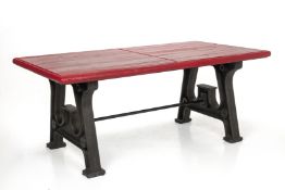 AN INDUSTRIAL STYLE CAST IRON AND RED PAINTED DINING TABLE