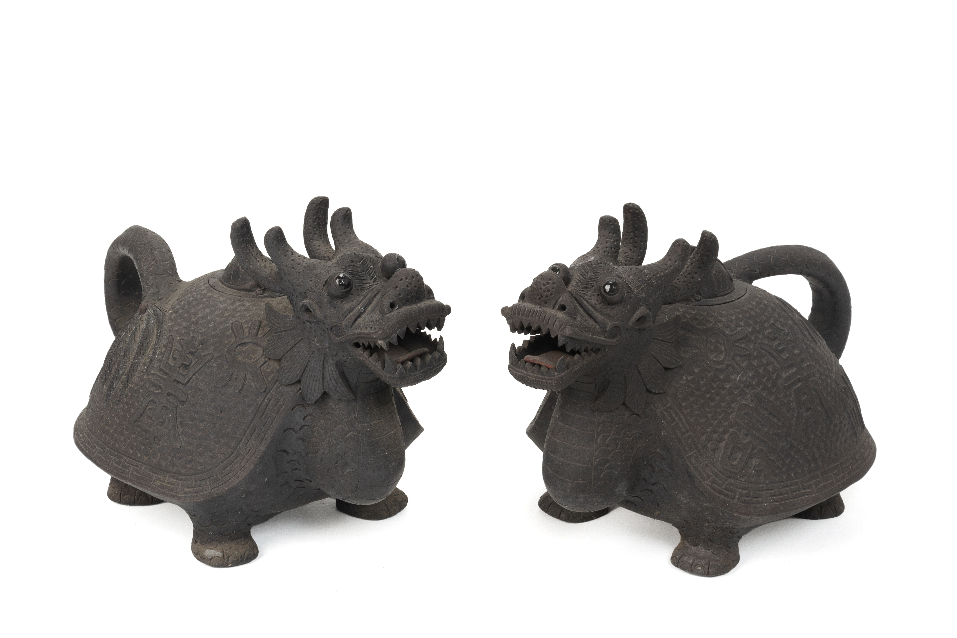 A PAIR OF POTTERY MODELS OF MYTHICAL BEASTS