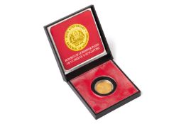 A SINGAPORE $100 1975 10TH ANNIVERSARY GOLD COIN