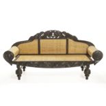 AN ANGLO INDIAN CARVED TEAK SOFA