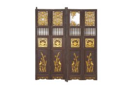 A PAIR OF CARVED AND GILT FOLDING DOORS OR SHUTTERS
