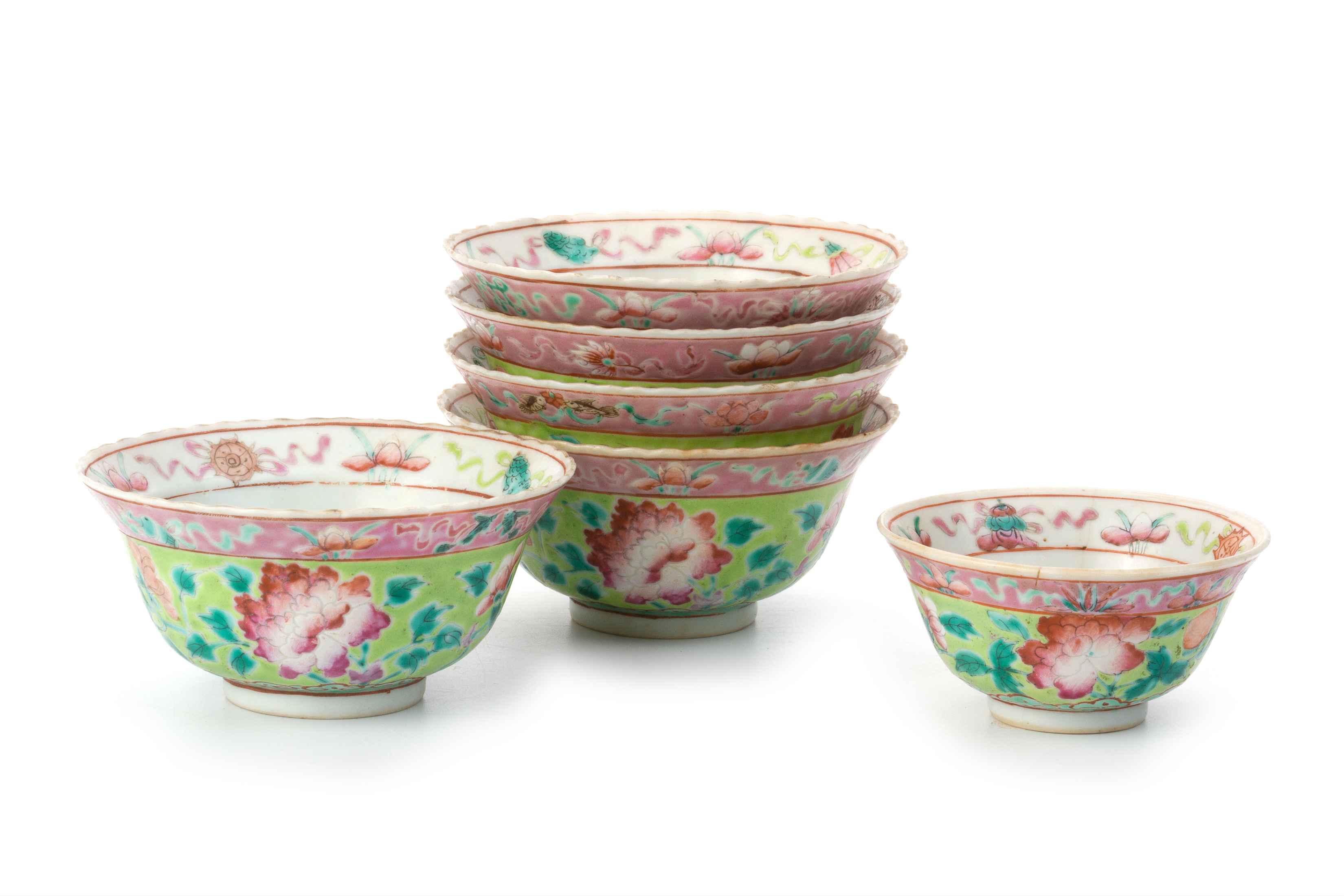 A GROUP OF SIX LIME GREEN GROUND FAMILLE ROSE BOWLS