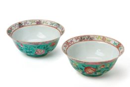 A NEAR PAIR OF TURQUOISE 'GROUND FAMILLE ROSE BOWLS