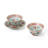 A PAIR OF FAMILLE ROSE TEA BOWLS AND A SAUCER