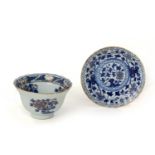 A GILDED BLUE AND WHITE TEA BOWL AND DISH