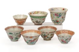 A MIXED GROUP OF SEVEN WHITE GROUND FAMILLE ROSE TEA BOWLS