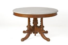 A CARVED AND MARBLE TOPPED CIRCULAR TABLE