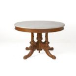 A CARVED AND MARBLE TOPPED CIRCULAR TABLE