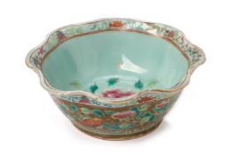 AN OLIVE GREEN CELADON GROUND 'PEONY' OFFERING BOWL
