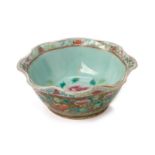 AN OLIVE GREEN CELADON GROUND 'PEONY' OFFERING BOWL