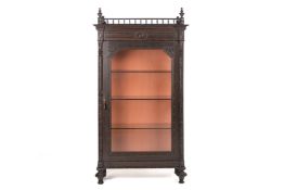 A CARVED AND GLAZED DISPLAY CABINET