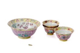 A GROUP OF FOUR PINK GROUND FAMILLE ROSE BOWLS