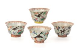 A GROUP OF FOUR SIMILAR FAMILLE ROSE 'MAGPIE' CUPS