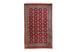 A RED GROUND BOKHARA TYPE WOOL RUG