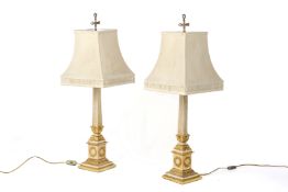 A PAIR OF GILT AND WHITE PAINTED METAL LAMPS