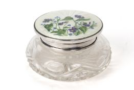 A SILVER AND ENAMEL TOPPED CUT GLASS DRESSING TABLE POT