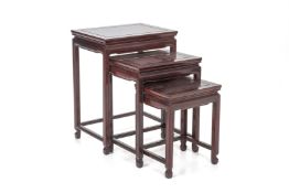 A SET OF THREE ROSEWOOD NESTING SIDE TABLES