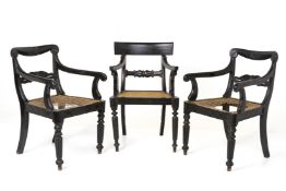 THREE ENGLISH COLONIAL EBONISED OPEN ARMCHAIRS