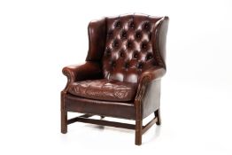 A LEATHER WING BACK ARMCHAIR BY TETRAD