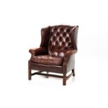 A LEATHER WING BACK ARMCHAIR BY TETRAD