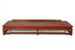 A CHINESE RED LACQUER LOW BENCH/ SEAT