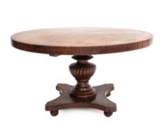 A CIRCULAR ANGSANA WOOD TABLE