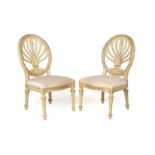 A PAIR OF CREAM PAINTED SIDE CHAIRS