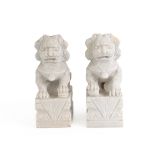 A PAIR OF CARVED STONE LIONS