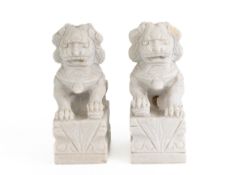 A PAIR OF CARVED STONE LIONS