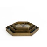 A SET OF THREE HEXAGONAL TRAYS AND A PAIR OF STONE BOOKENDS