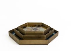 A SET OF THREE HEXAGONAL TRAYS AND A PAIR OF STONE BOOKENDS