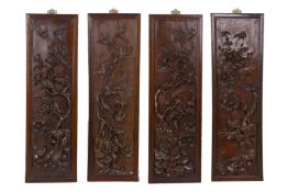 A SET OF FOUR CARVED ROSEWOOD PANELS