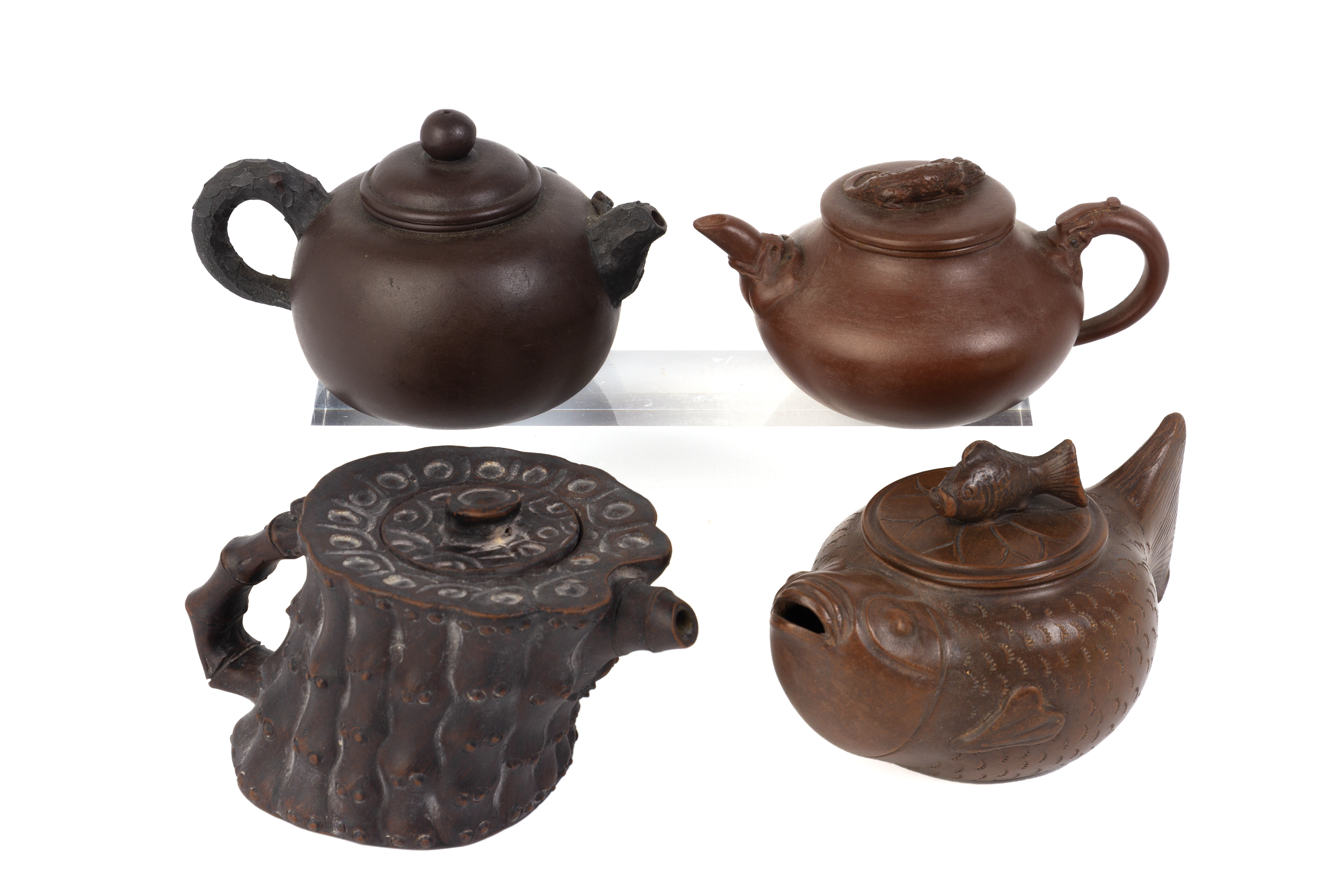 A GROUP OF FOUR YIXING POTTERY TEAPOTS