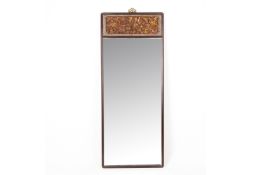 A TALL RECTANGULAR WALL MIRROR WITH CARVED PANEL