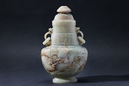 A CARVED JADE TWIN HANDLED VASE AND COVER