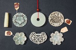 SEVEN CARVED AND PIERCED JADE PLAQUES AND CARVINGS