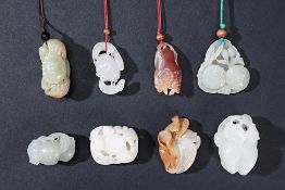 A GROUP OF EIGHT JADE CARVINGS AND TOGGLES