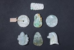 A GROUP OF SEVEN CARVED JADE PENDANTS