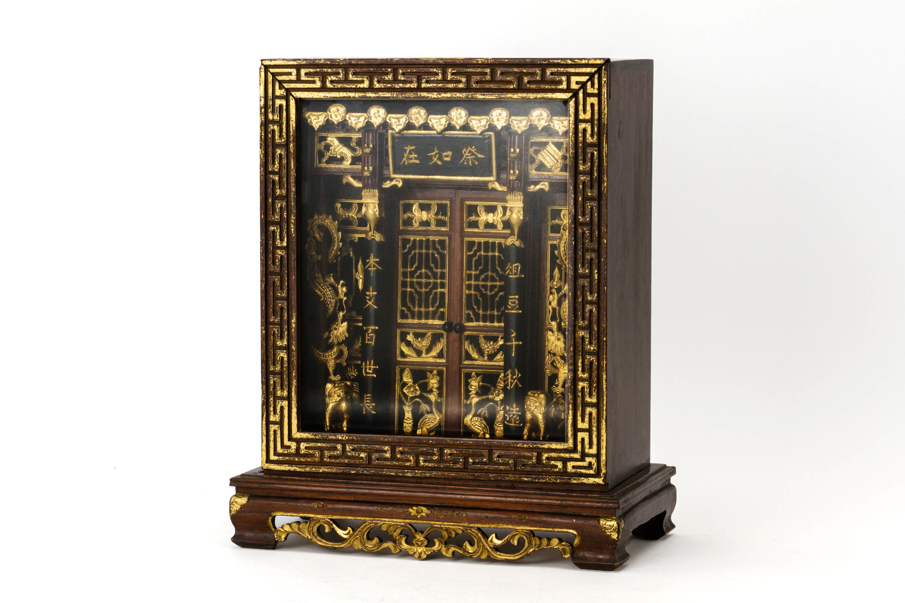 A CARVED AND PARCEL GILT ANCESTRAL SHRINE CABINET