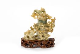 A CARVED JADE MYTHICAL BEAST VASE AND COVER