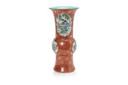 A CORAL GROUND FAMILLE ROSE GU SHAPED VASE