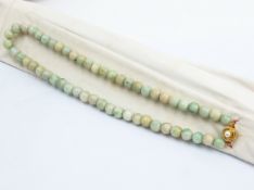 A GROUP OF THREE JADE BEAD SINGLE STRAND NECKLACES