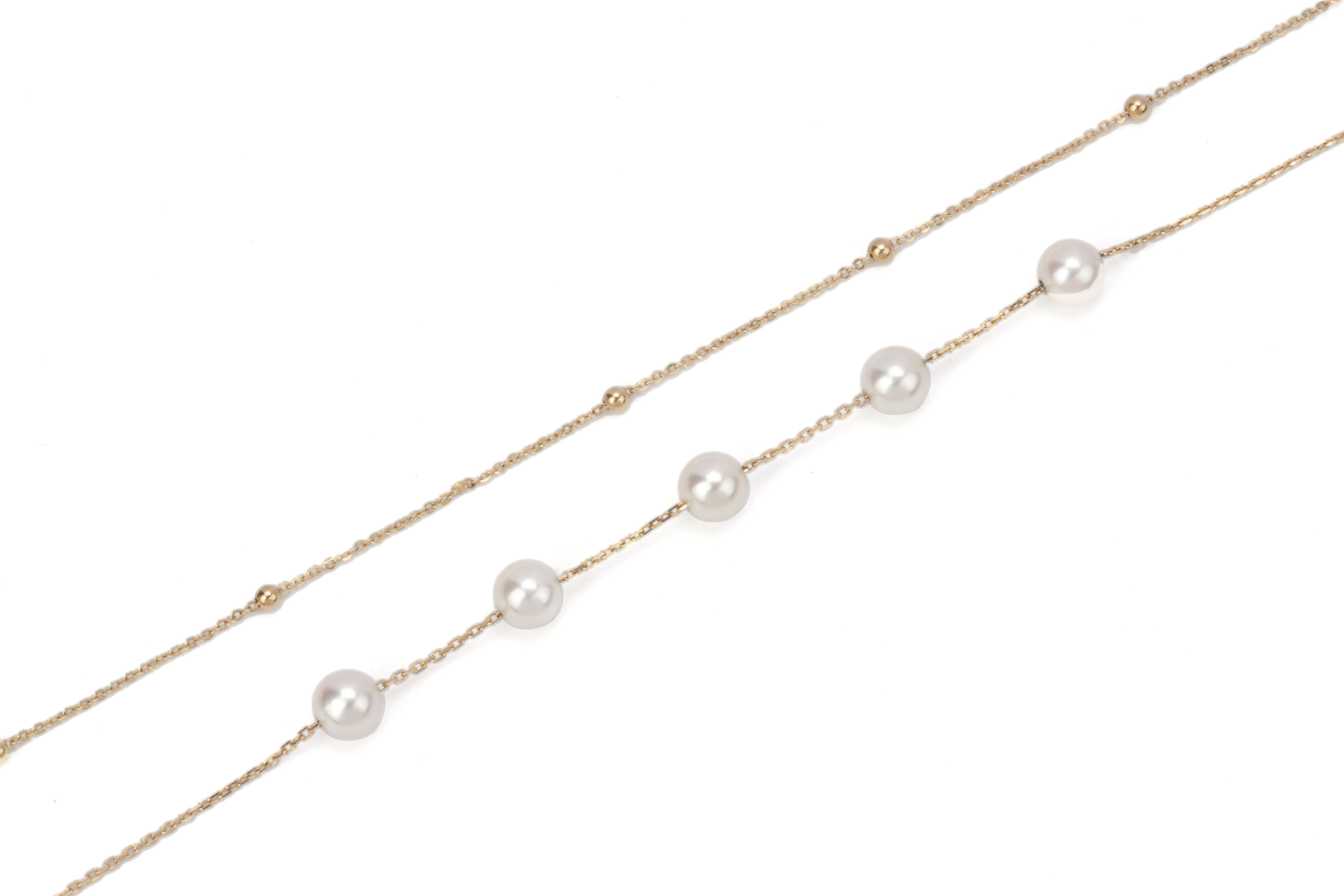 AN AKOYA CULTURED PEARL GOLD DOUBLE STRAND BRACELET