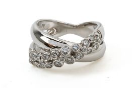 A WHITE GOLD AND DIAMOND CROSSOVER RING